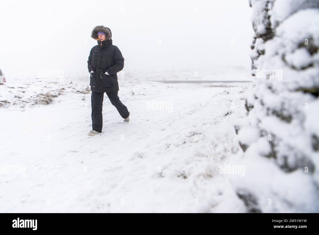 **NORMAL USAGE FEES APPLY**   Coalcleugh, Northumberland , UK - Saturday 17th December 2022;   A women battles the wintery conditions in Northumberlan Stock Photo