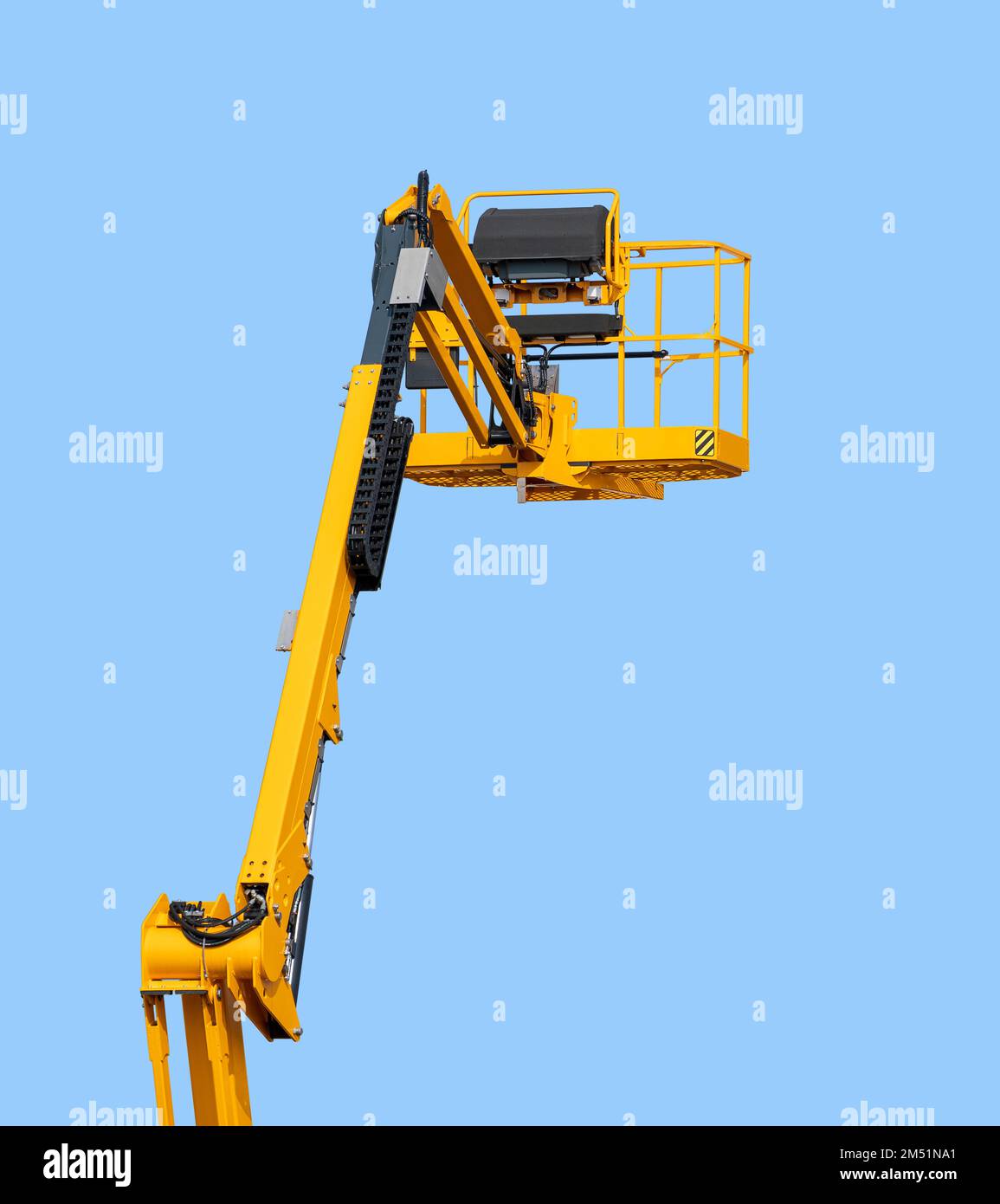 Yellow aerial work platform in front of blue sky Stock Photo