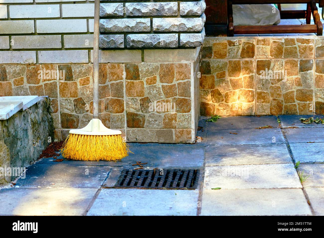 Plastic mop for cleaning in the yard of the house on a sunny day Stock Photo