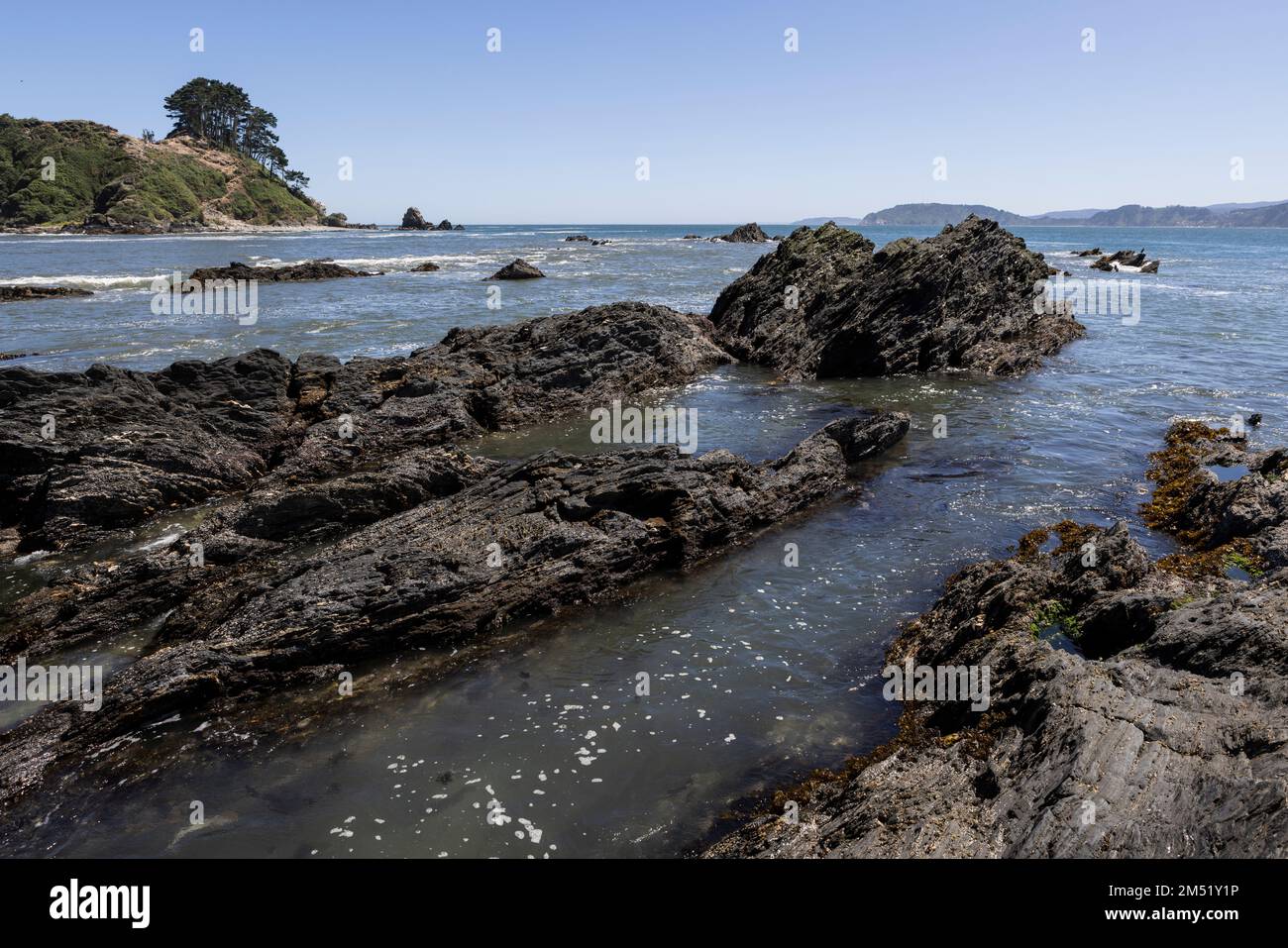 Isla Maiquillahue and big, serrated rocks in the Pacific Ocean of Chile ...