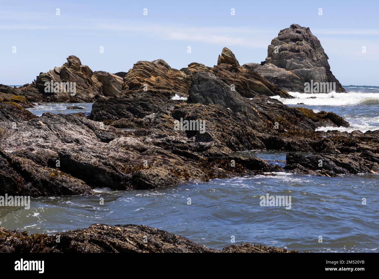 serrated rocks at Isla Maiquillahue in the Pacific Ocean of Chile Stock Photo