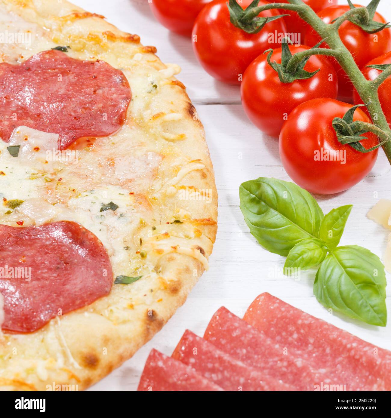 Pizza salami baking ingredients square on wooden board wood Stock Photo