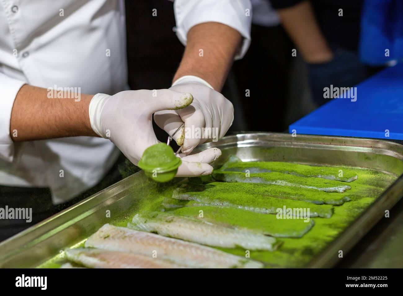 The chef cooking sole. Marinating fish with a mixture of 5 spices. Green spices Stock Photo