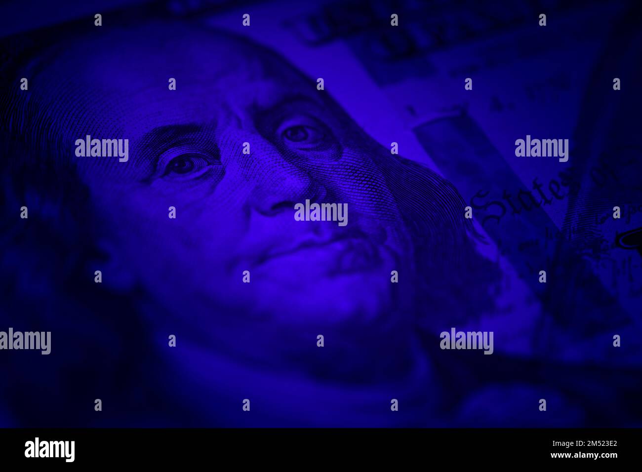 Close up shot of Benjamin Franklin on hundred dollar bill with vignette and blue color Stock Photo