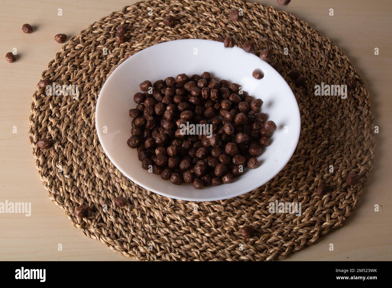 photo of dried chocolate balls lying in a deep plate on a straw stand