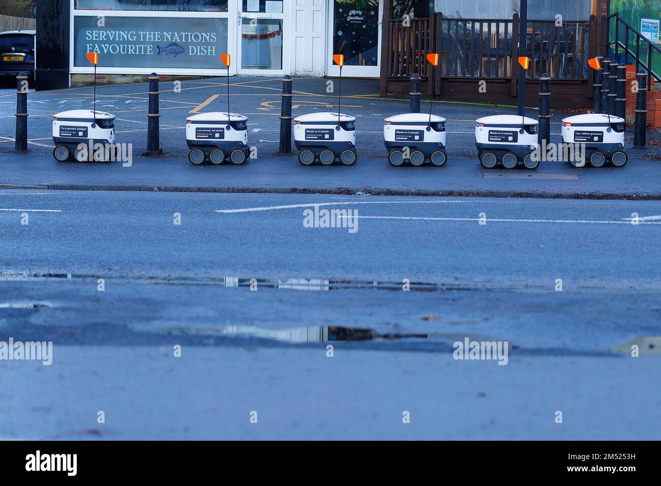 A line of autonomous robots await instructions before carrying out