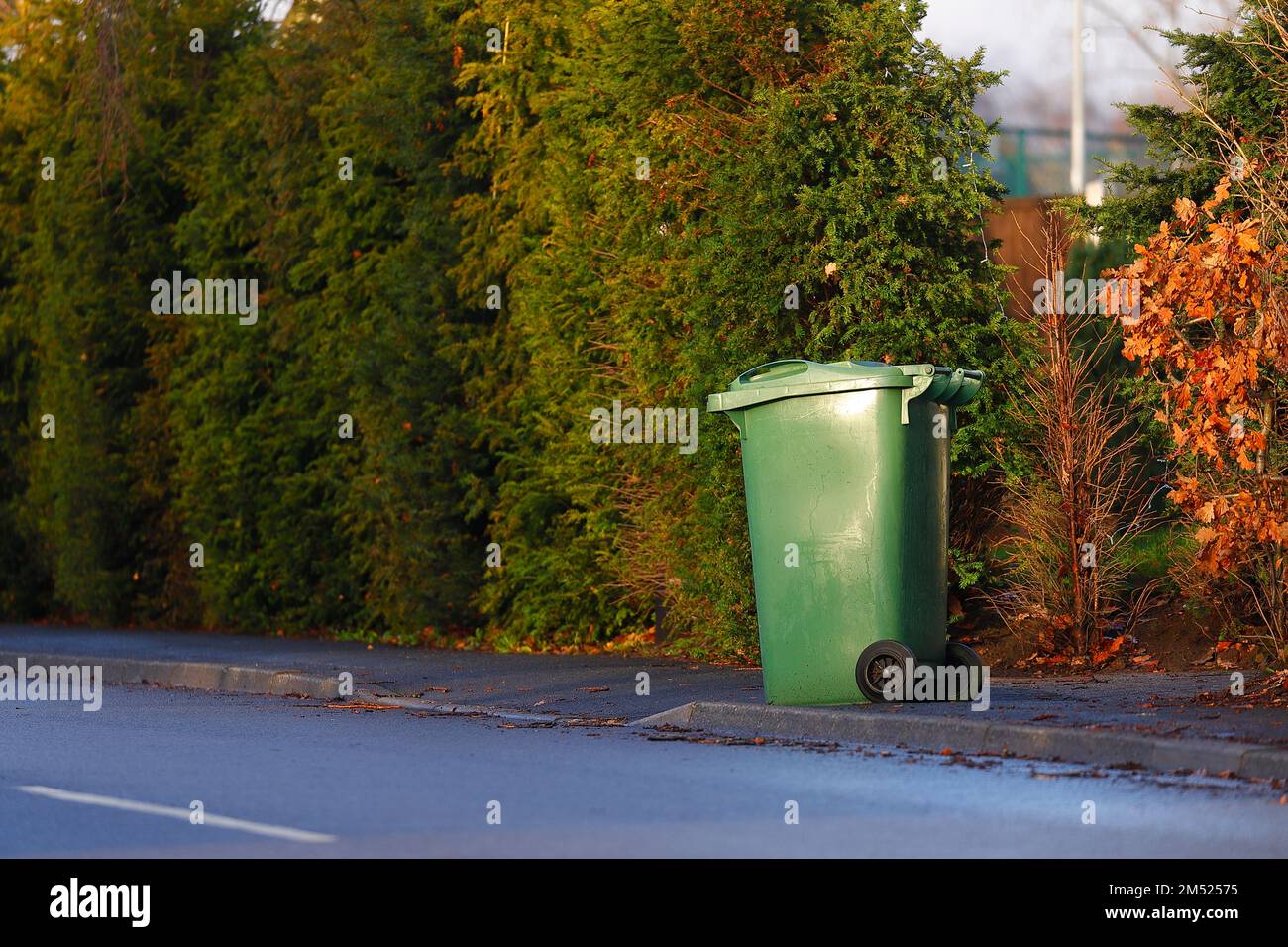 A Green (recycle) wheelie bin on a pavement in Leeds,WEst Yorkshire,UK