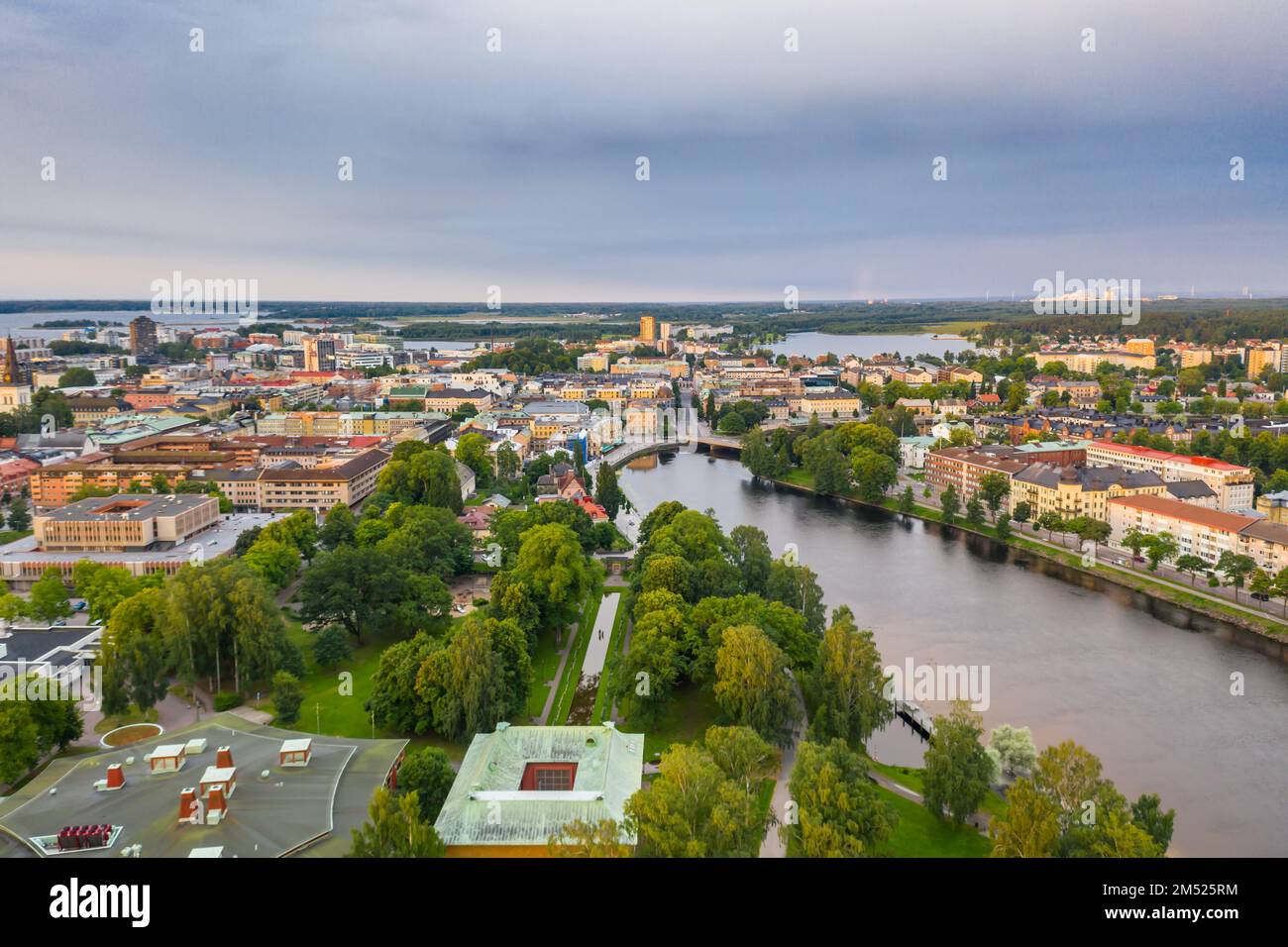 An aerial view of a town with a river and old buildings in cloudy sky ...
