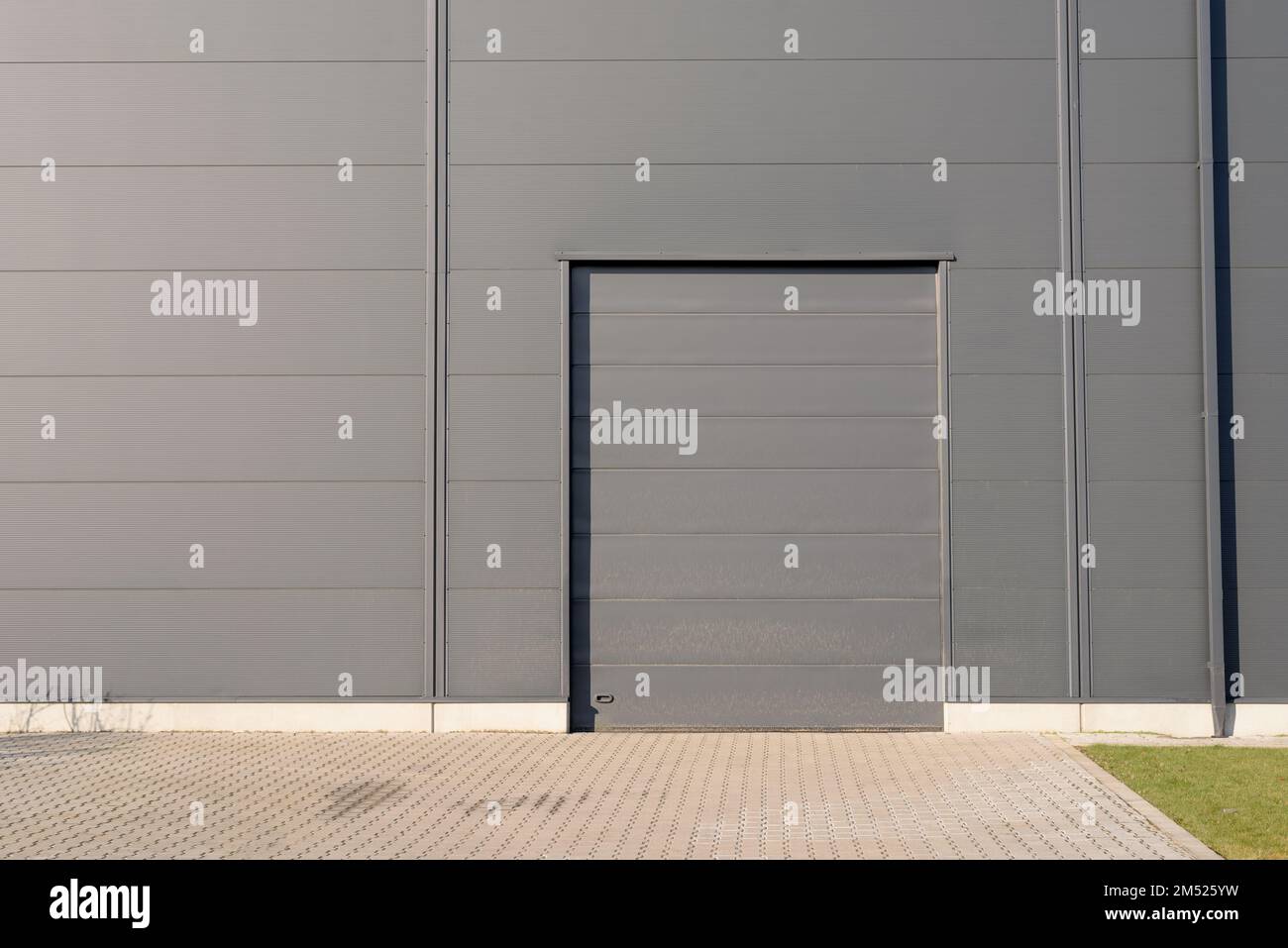 Closed grey metal door of warehouse building Stock Photo