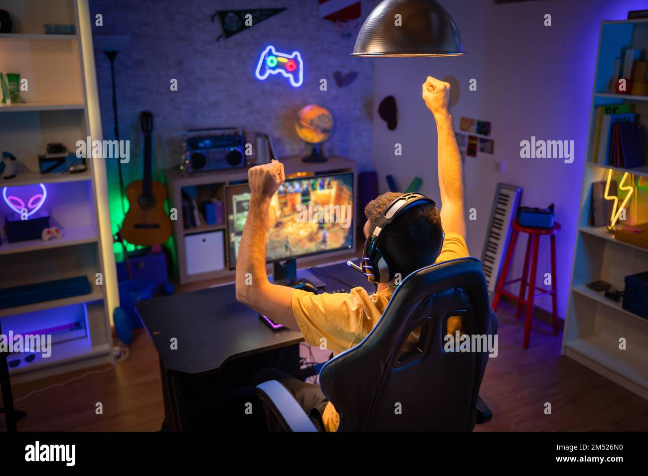 Professional Gamer winning and celebrating victory Online Video Game on Computer  Stock Photo