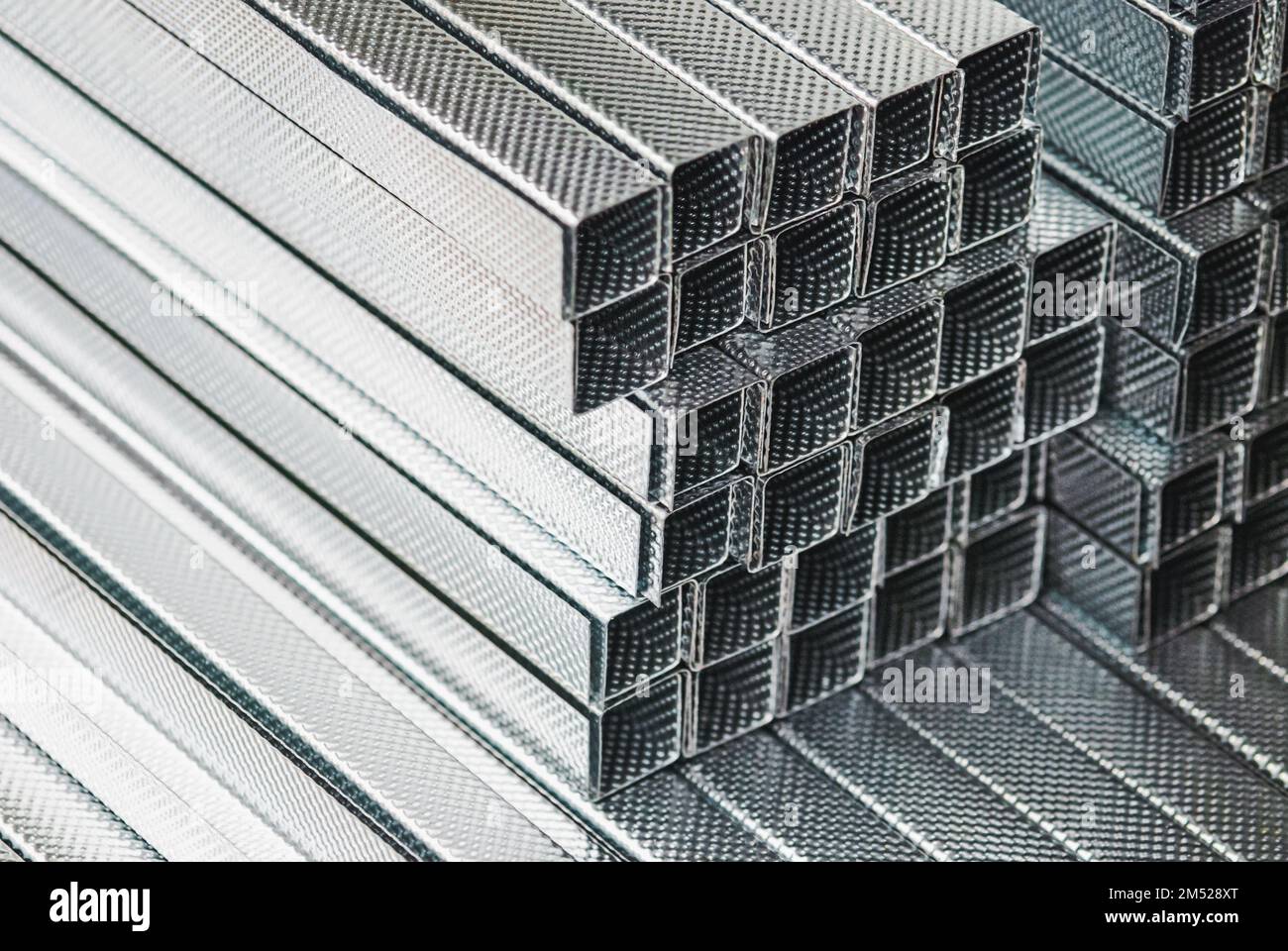 Metal C profile studs for drywall and ceiling construction, corrugated C shaped metal profiles stacked Stock Photo