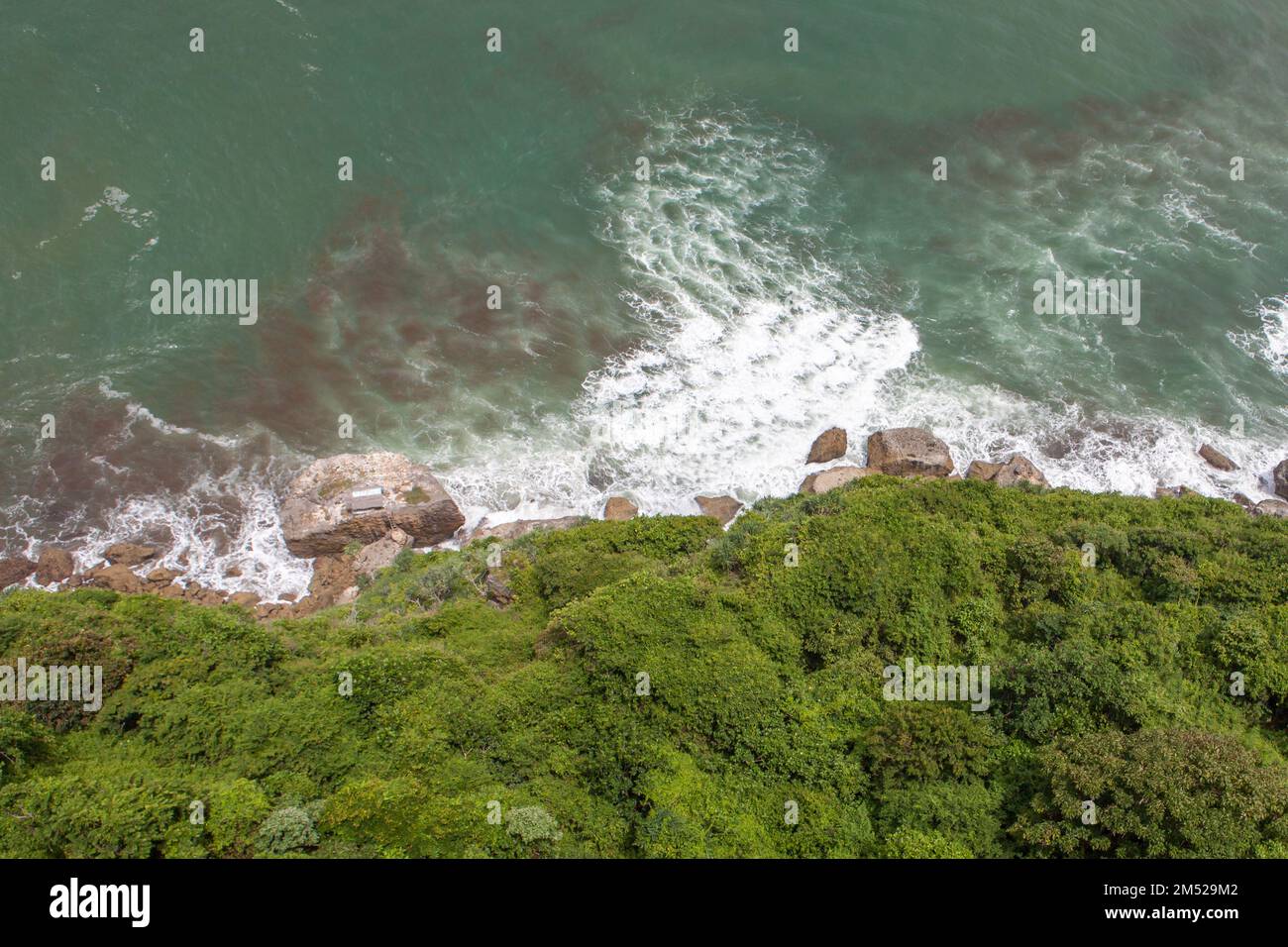 Green lush and sea at Java coast in Indonesia. Stock Photo