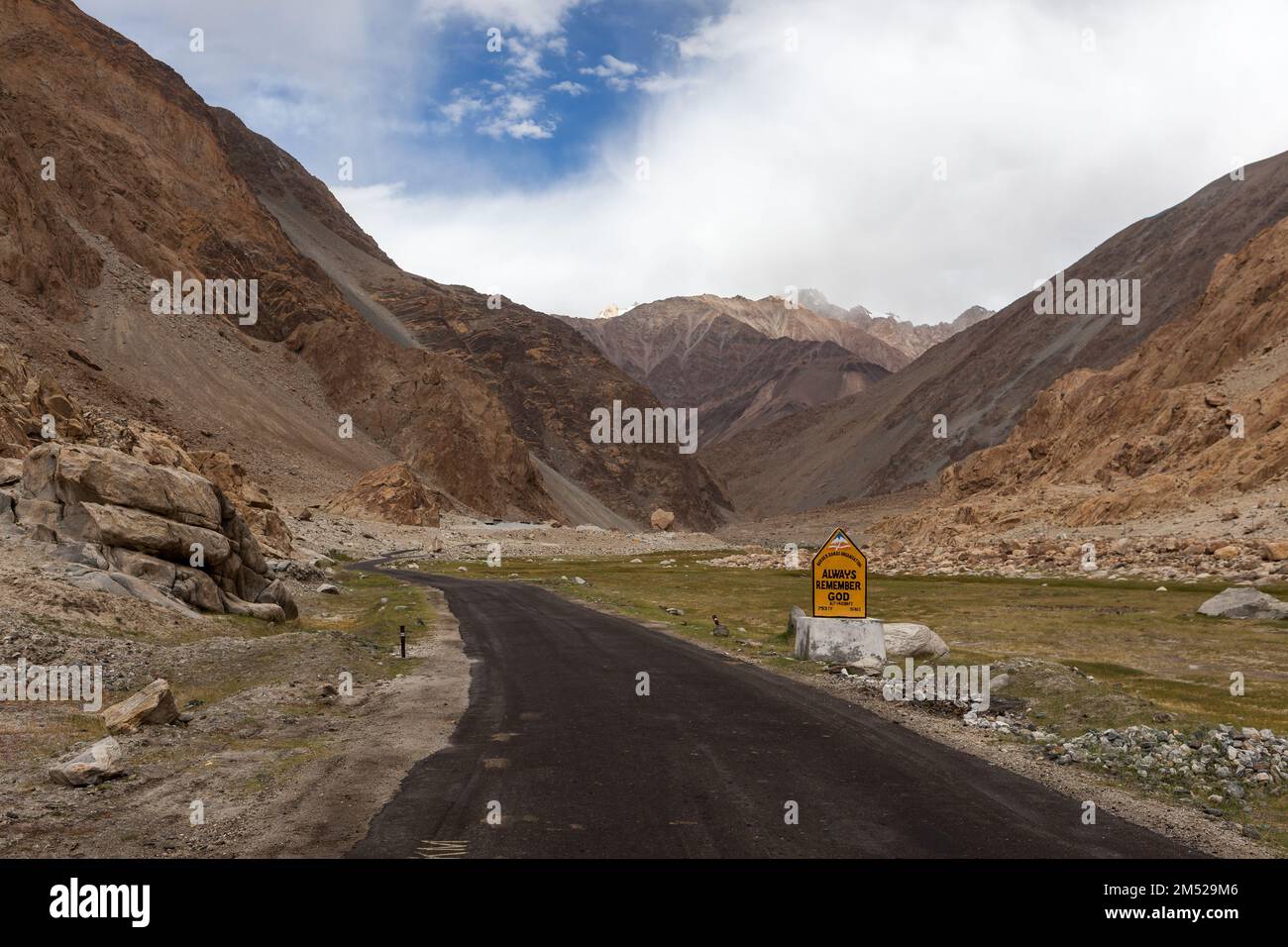 Always Remember God sign on the road in Ladakh mountains. Stock Photo