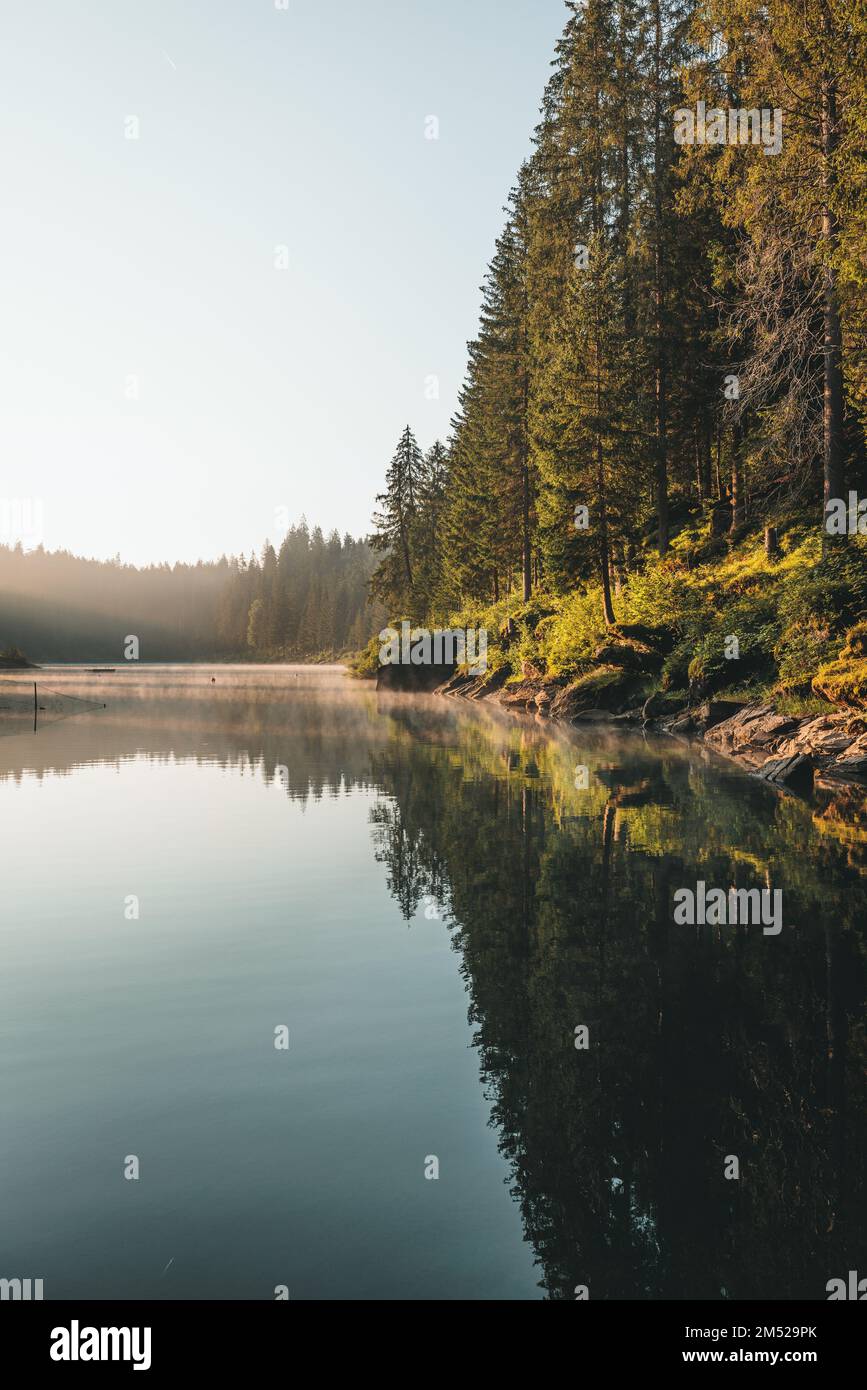 A Vertical landscape of lake with autumn trees and hills Stock Photo ...