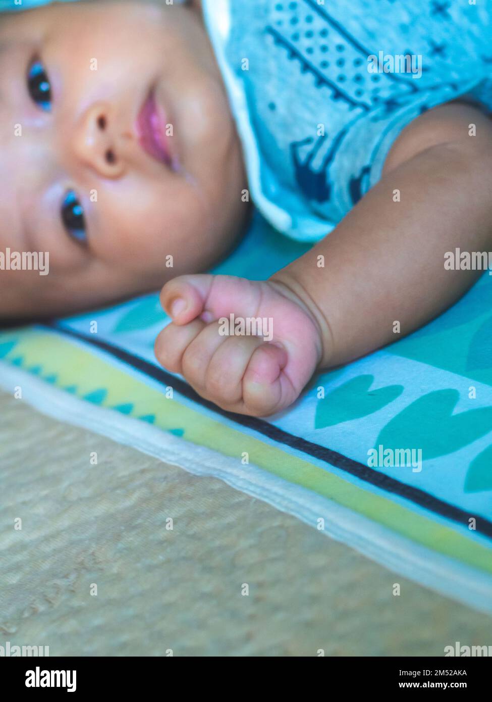 Baby Asian and nationality Thai is sleeping with fists Stock Photo Alamy