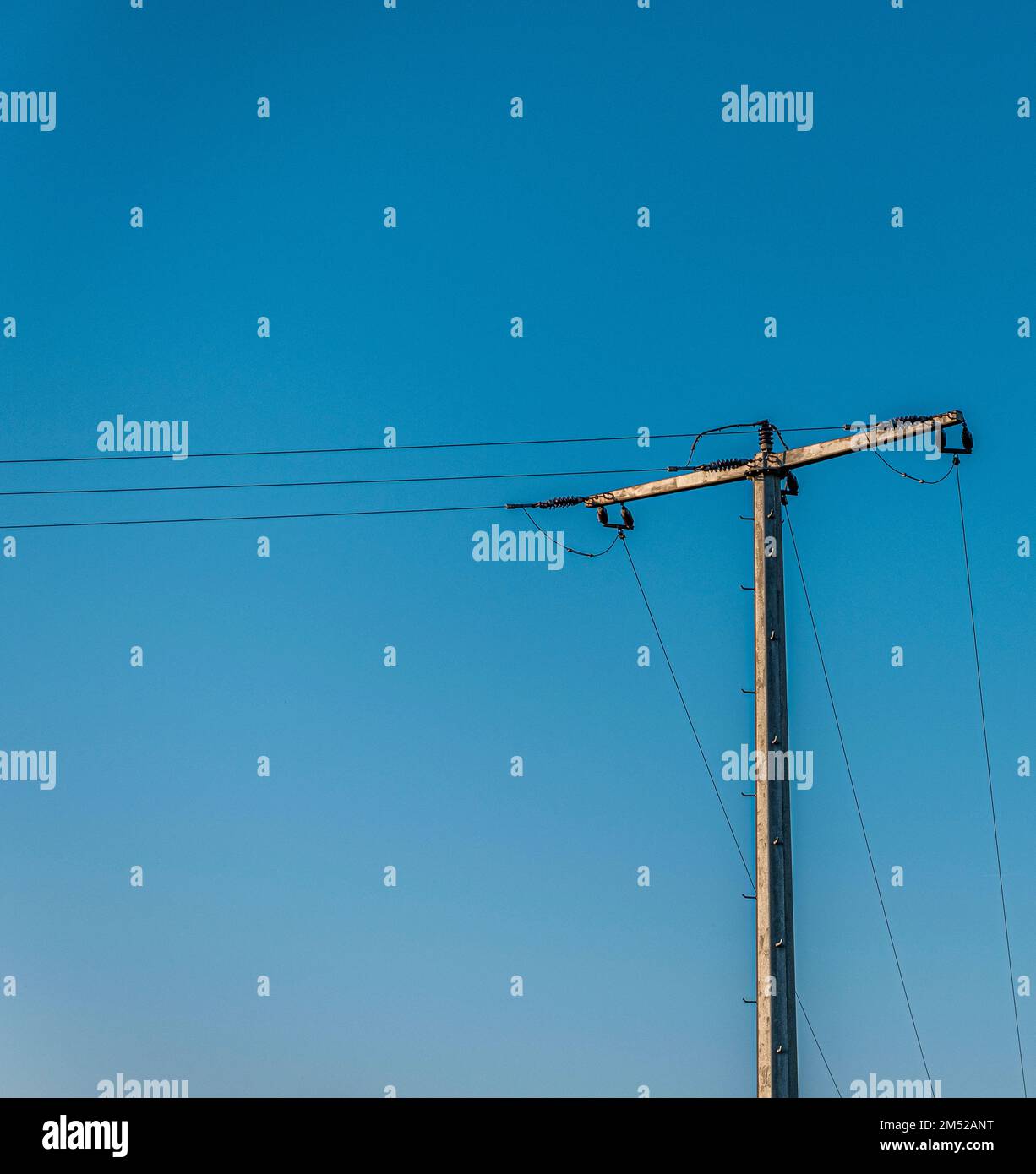 The electrical wires of high voltage tower against blue sky Stock Photo ...