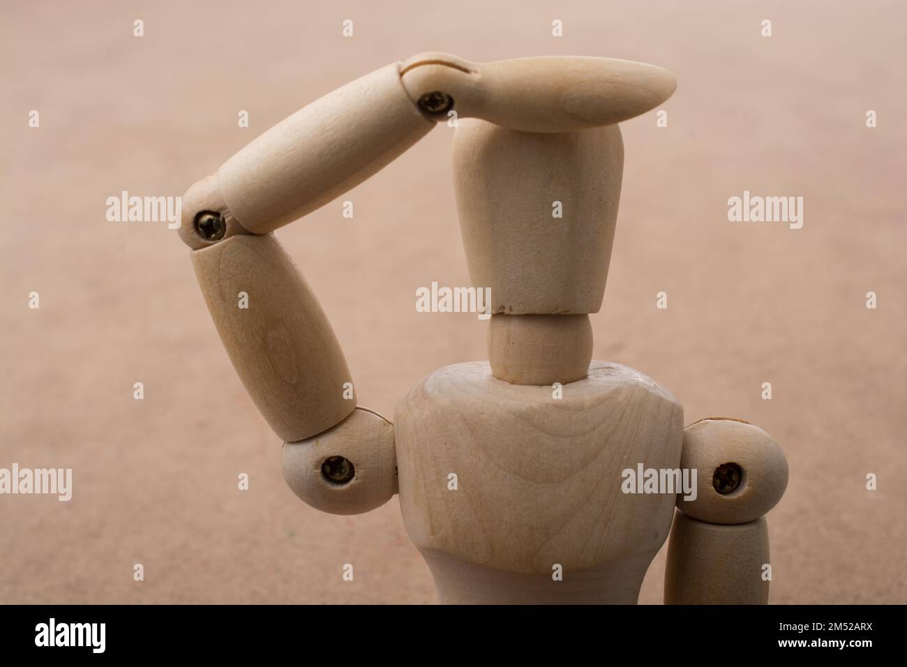 Anatomy doll making a hand gesture on a wooden background Stock Photo