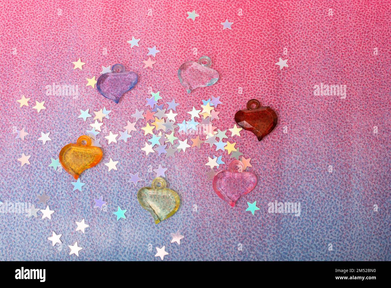 Colorful heart shape beads and tiny stars as love concept Stock Photo