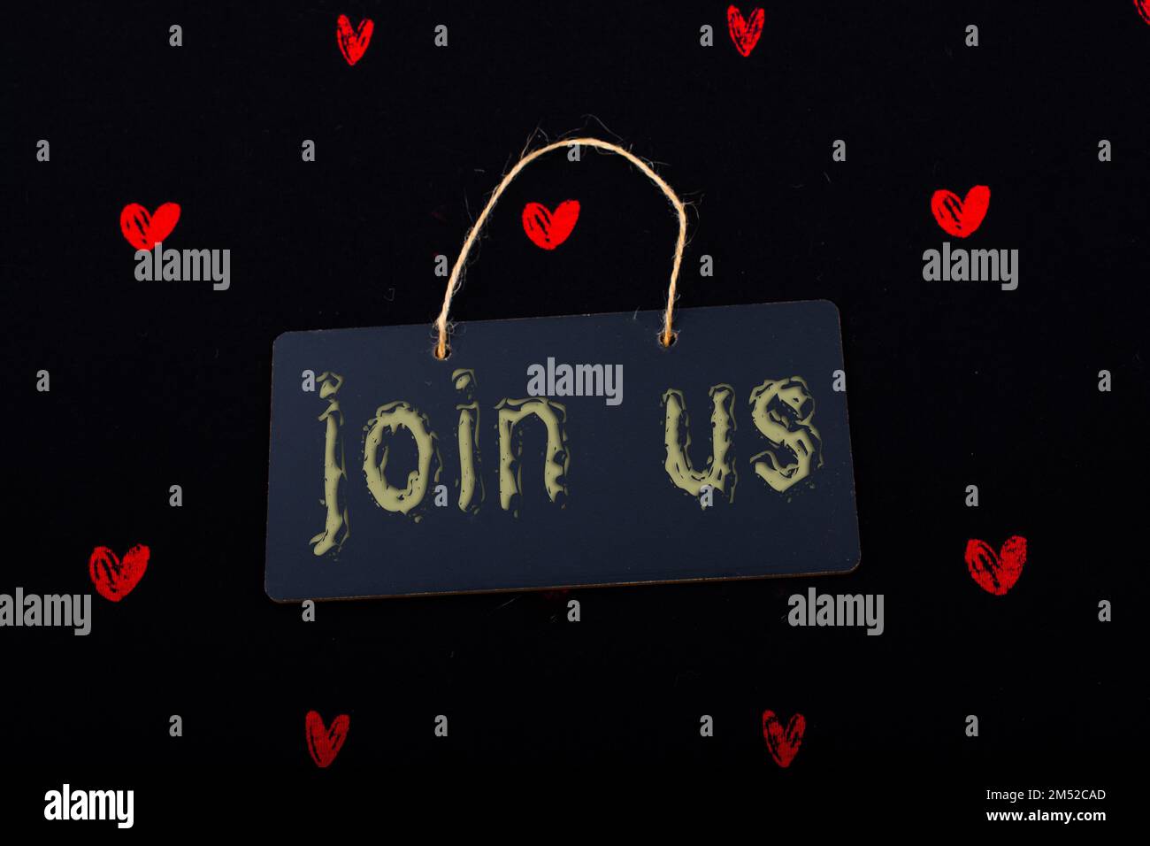 Rectangular shaped black notice board and red hearts on black background Stock Photo