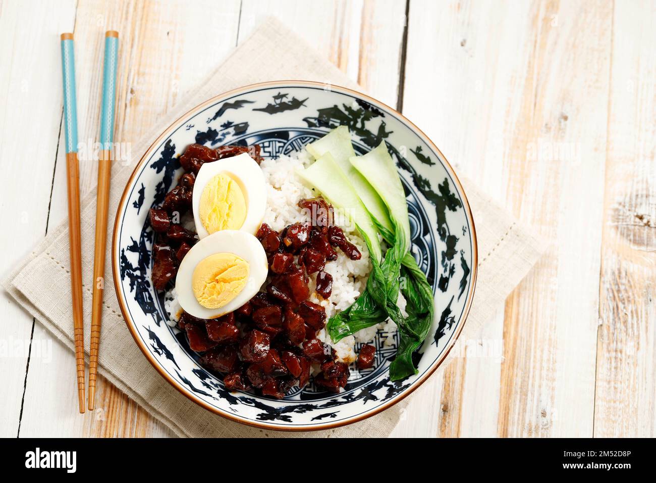 Lu Rou Fan, Braised Pork with Chinese Five Spice and Soy Sauce. Served with Bok Choy and Eggs, Overhead View on Wooden Table Stock Photo