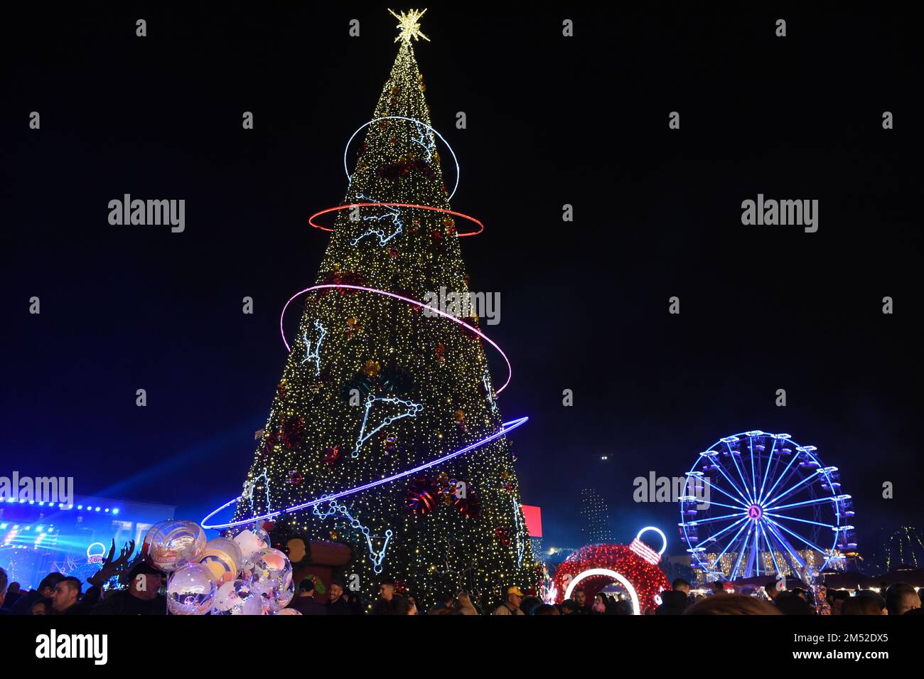 Tirana, Albania. 24th Dec, 2022. A Christmas tree is lit up in