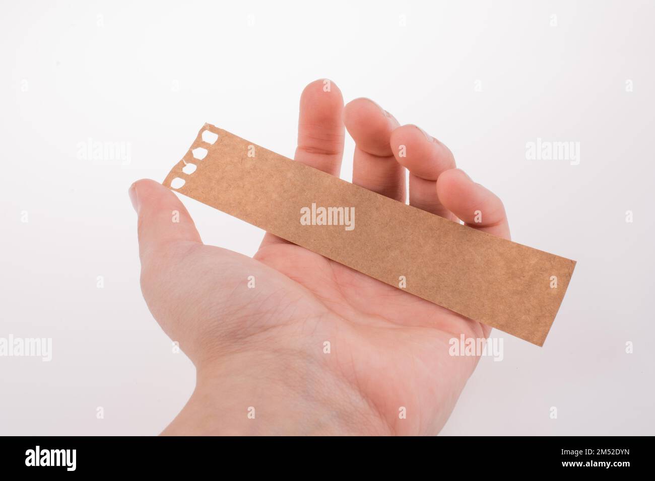 Hand Rested On Paper Hand holding a piece of paper on a white background Stock Photo - Alamy