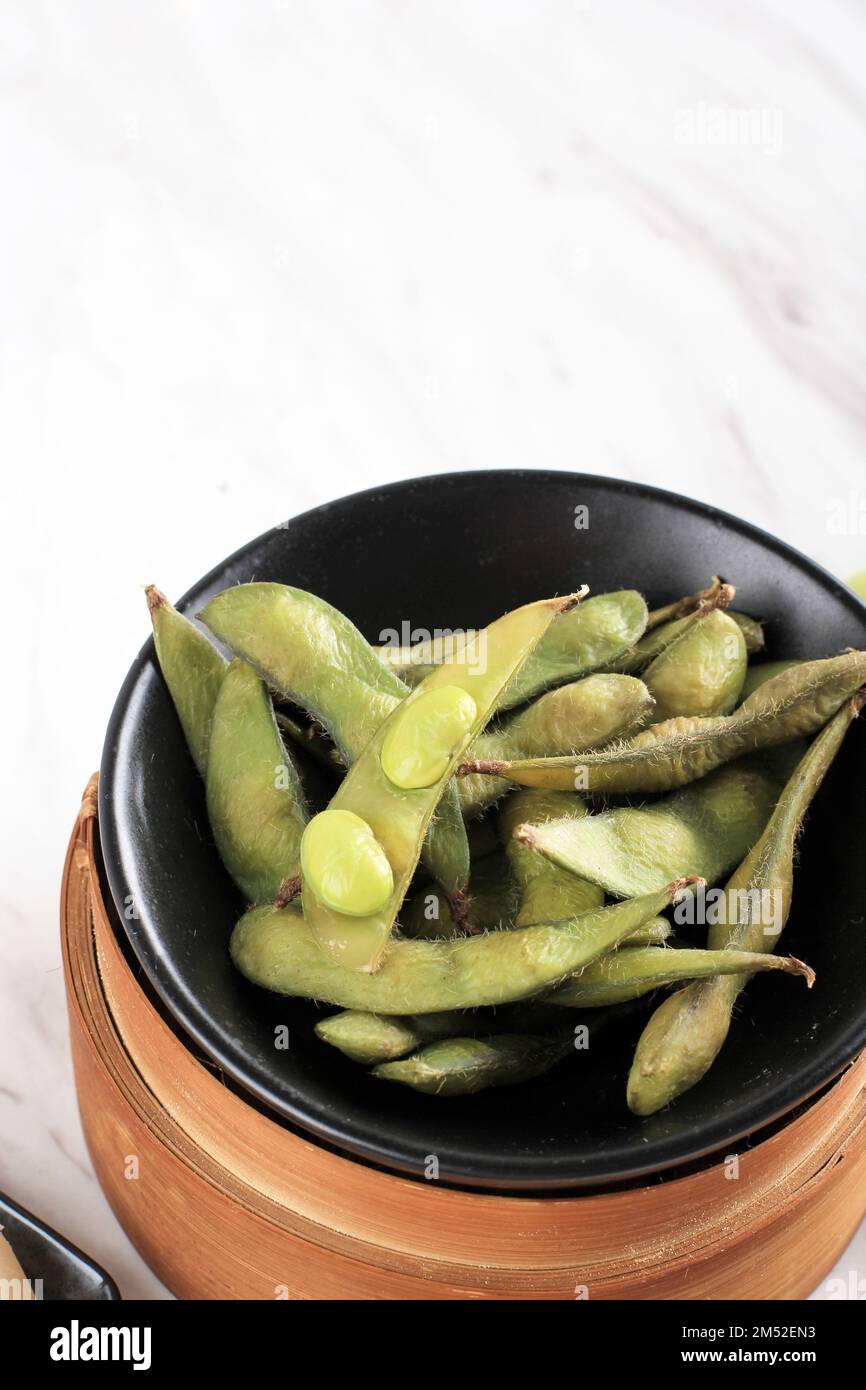 Steamed Frozen Edamame Pods on White Table, Copy Space for Text Stock Photo Alamy