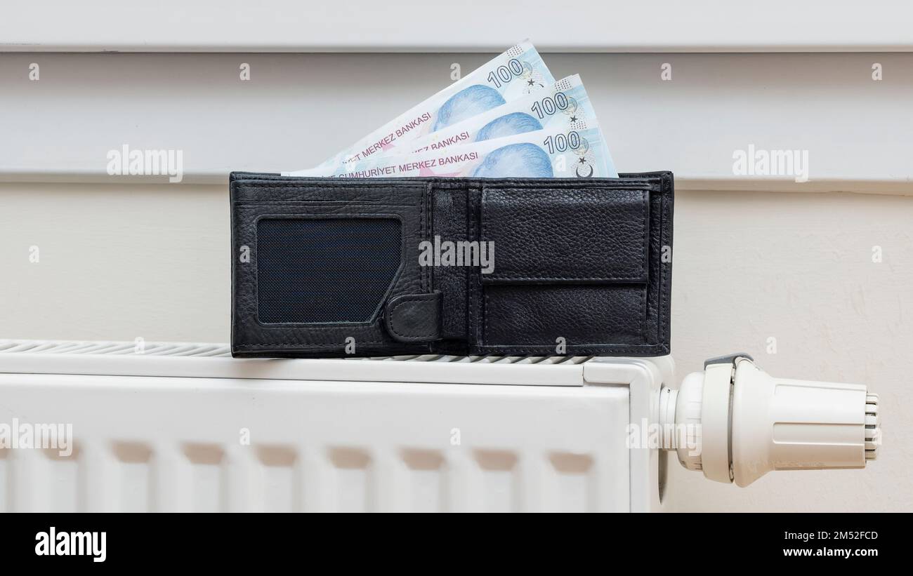 A wallet and Turkish Lira banknotes on heating radiator - expensive ...