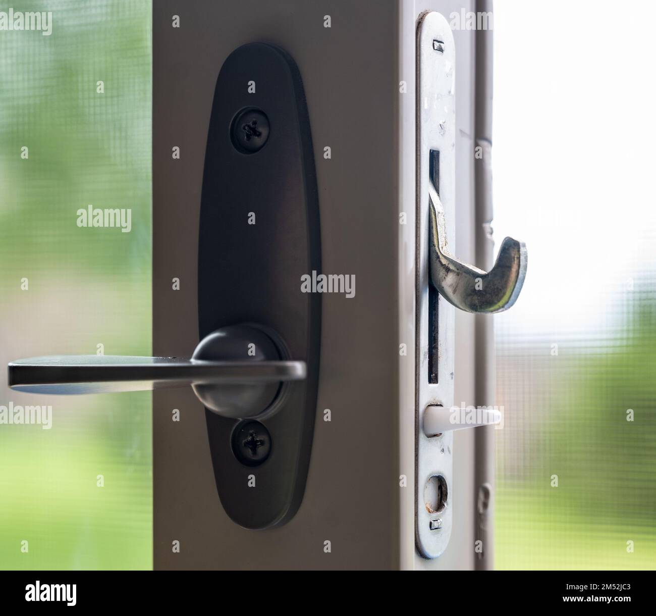 Handle, locking hardware, and jam to a sliding glass and screen door