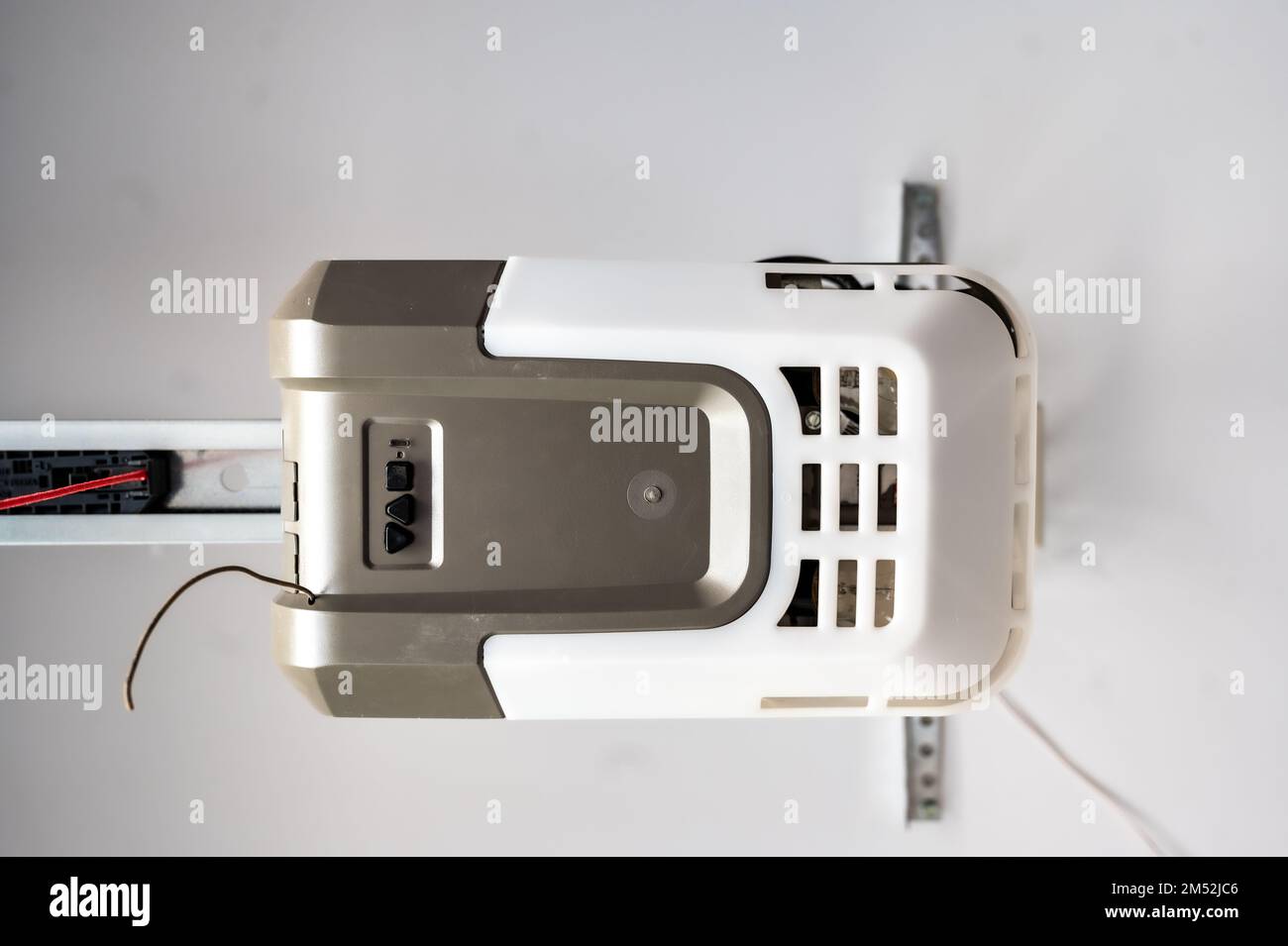 Upward angle looking at the motor box for a garage door opener pulley