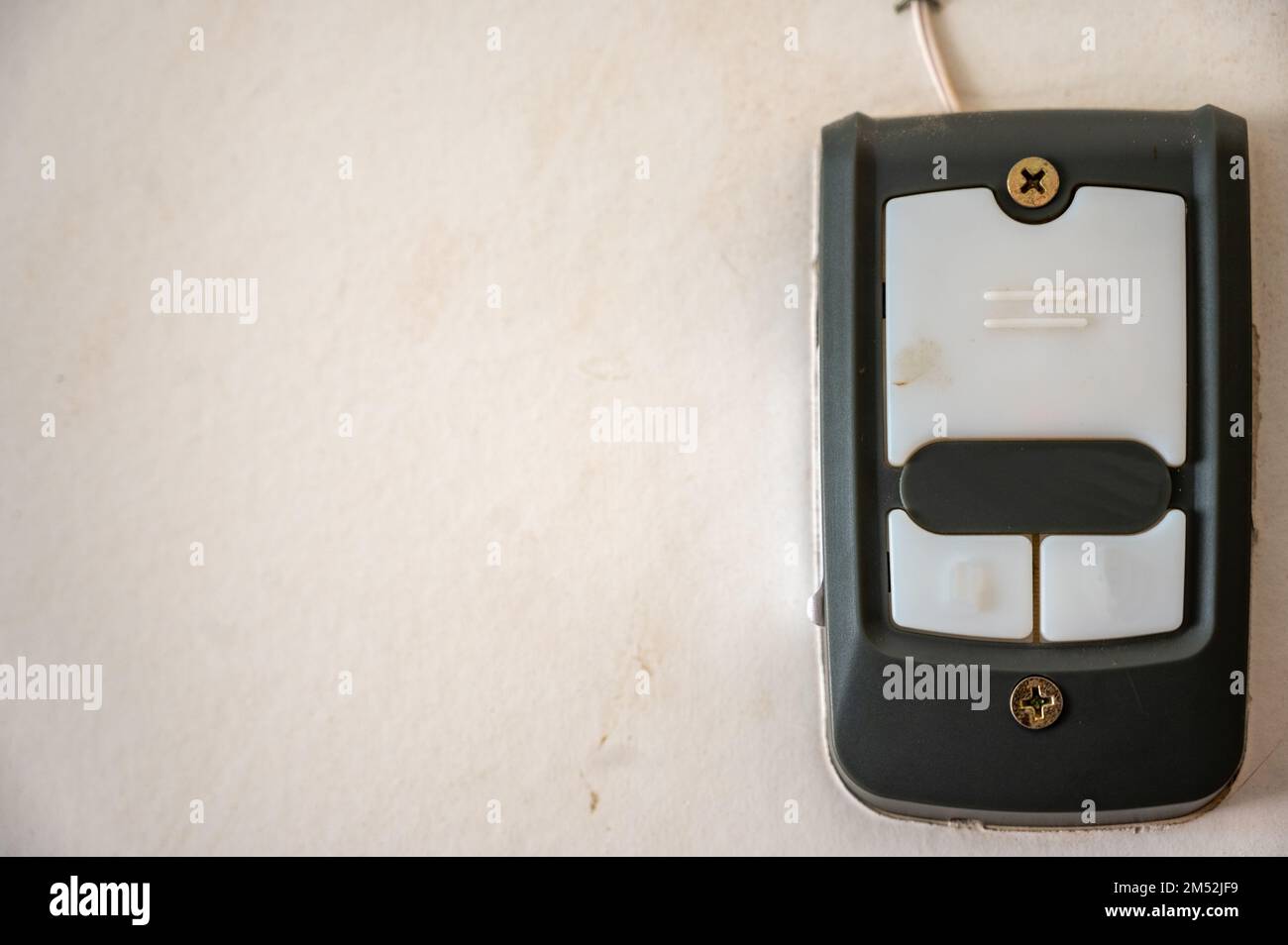 Drywall with a mounted garage door opener control panel Stock Photo Alamy