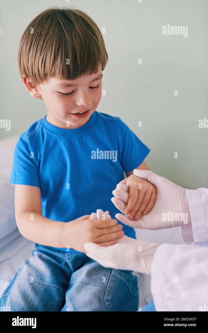 What strong hands you have. a little boy holding his doctors hands. Stock Photo
