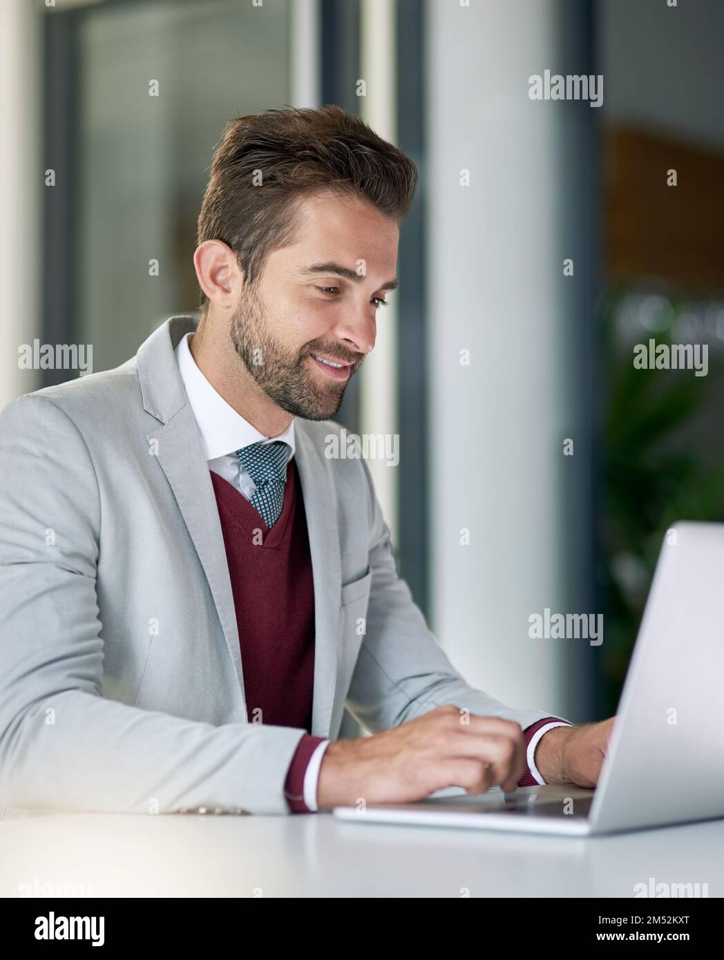 Its all about getting those results. a businessman using a laptop at his office desk. Stock Photo