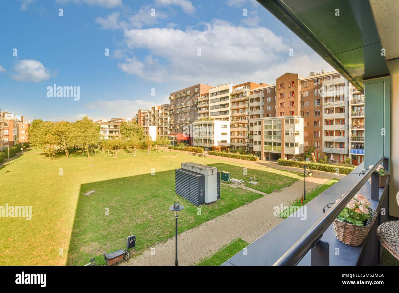 an outside area with buildings in the background and green grass on the ...