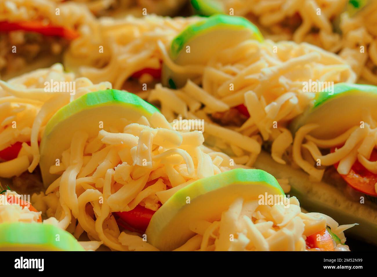 Stuffed zucchini with minced meat, tomatoes and cheese. Close-up top view. Healthy food. Recipe delicious food at home. Stock Photo
