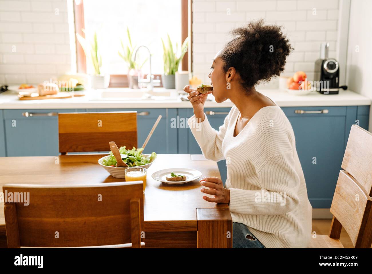 African woman sitting side view hi-res stock photography and images - Alamy