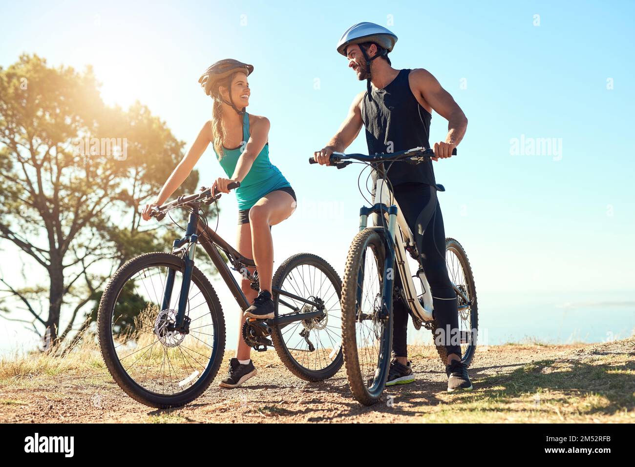 The main goal should always be to have fun. a happy young couple out mountain biking together. Stock Photo