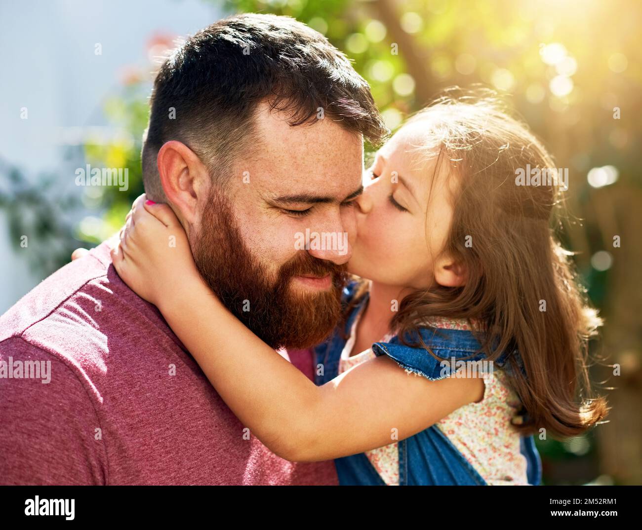 First rule of raising a daughter Love her. an adorable little girl giving her father a kiss outdoors. Stock Photo