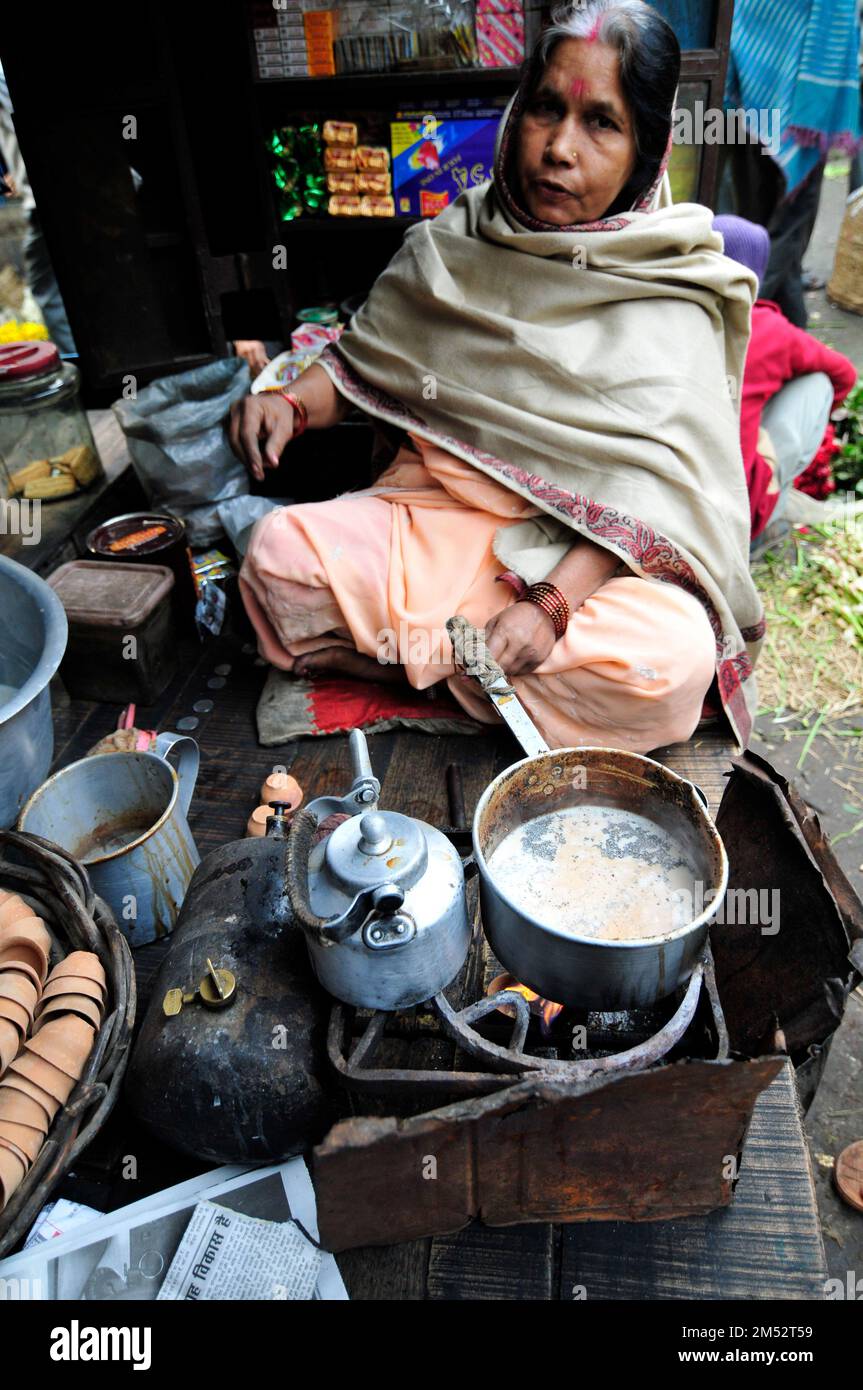 A Bengali woman preparing traditional Indian milk tea in Kolkata, India