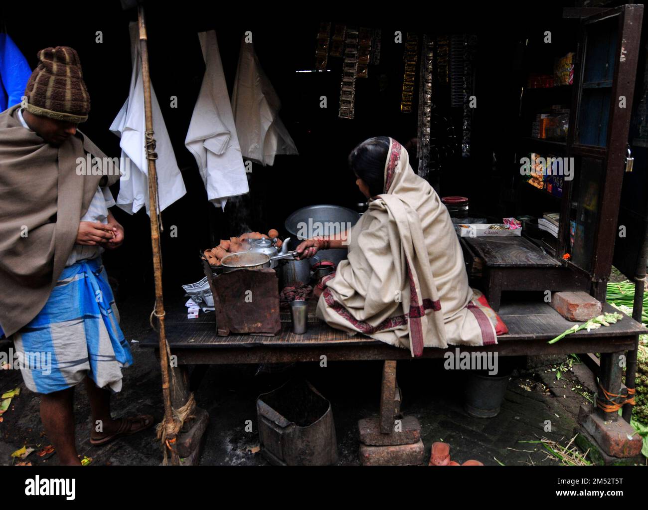 A Bengali woman preparing traditional Indian milk tea in Kolkata, India