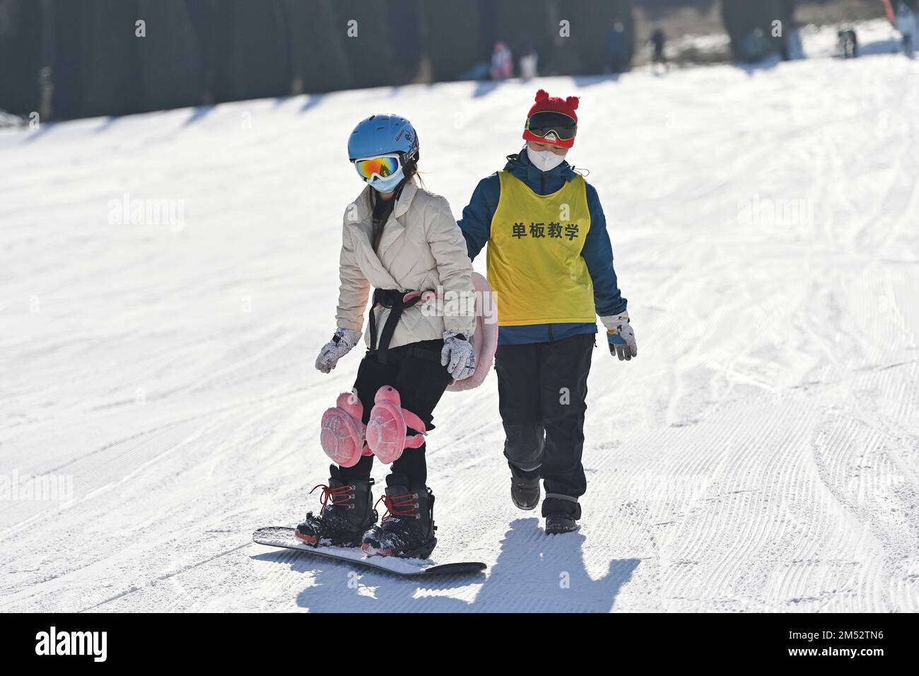 WEIFANG, CHINA - DECEMBER 25, 2022 - Tourists practice skiing under the guidance of an instructor at a ski resort in Weifang, East China's Shandong pr Stock Photo