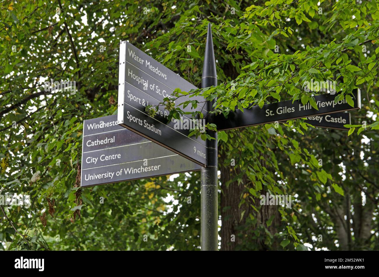 A signpost for pedestrians showing the direction of a number of attractions in the city of Winchester, Hampshire. Stock Photo