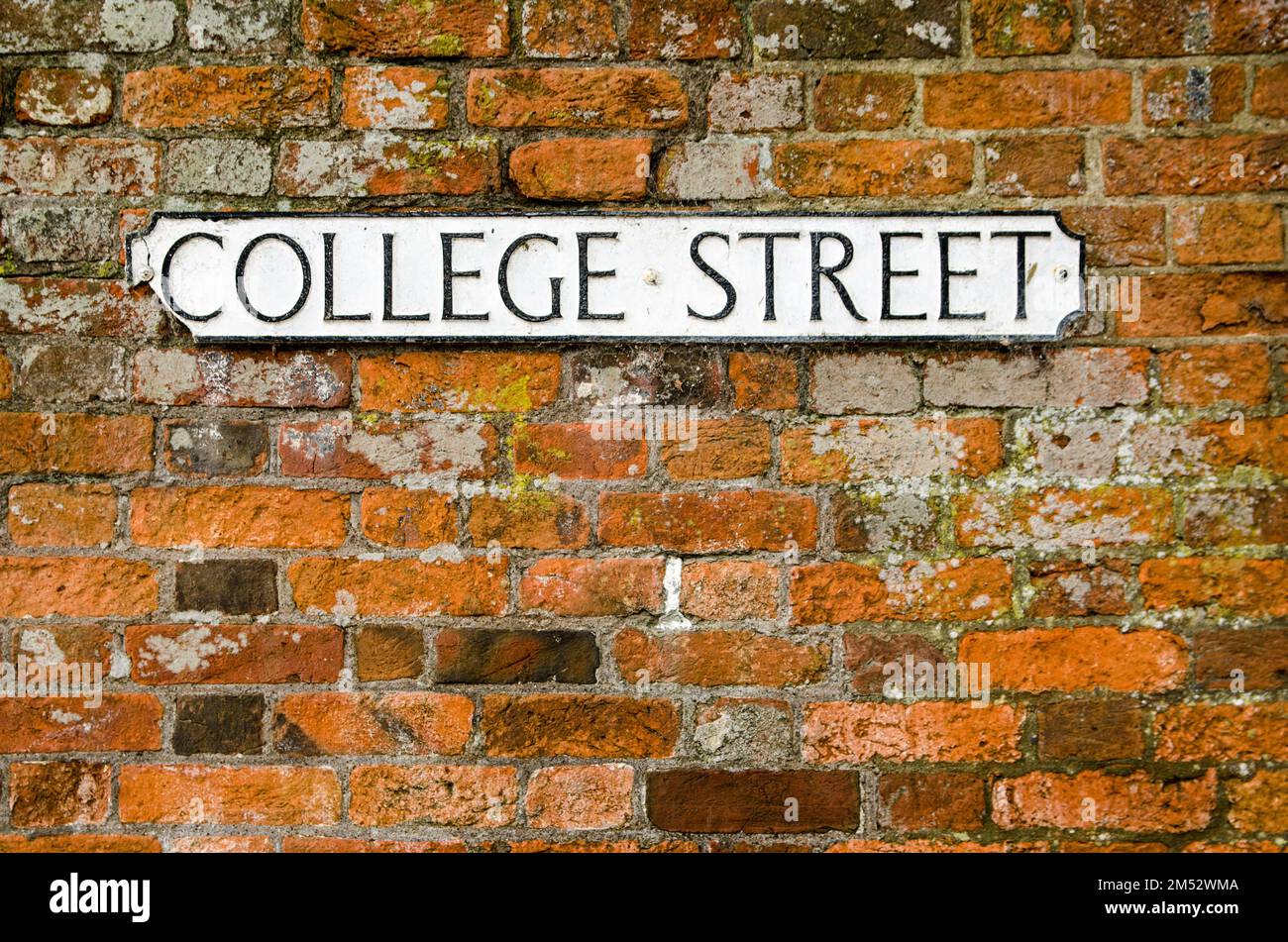 A cast iron road sign for College Street in Winchester, Hampshire.  Space for copy. Stock Photo