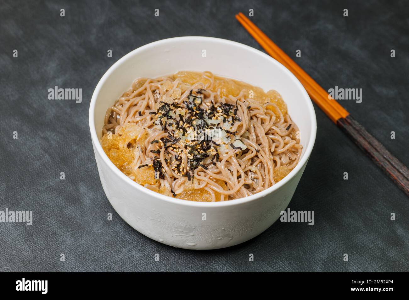 Korean food Naengmemilguksu, a winter delicacy, this buckwheat noodle dish is served in a cold chicken- or beef-based broth and topped with cold slice Stock Photo
