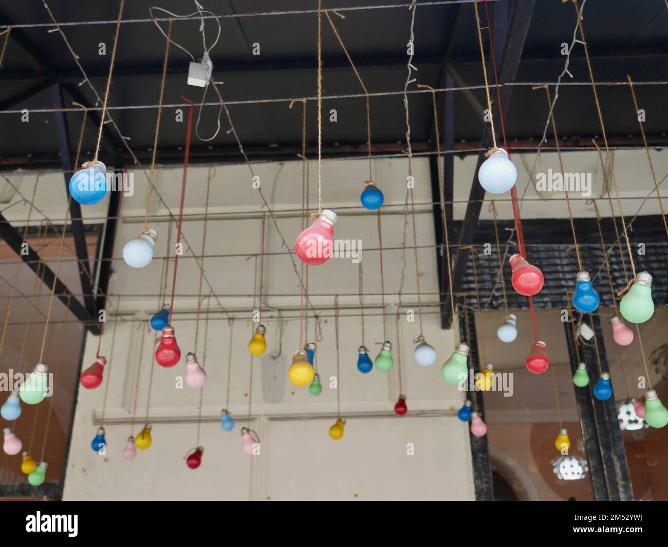 Colorful light bulbs hanging from ceiling Stock Photo Alamy