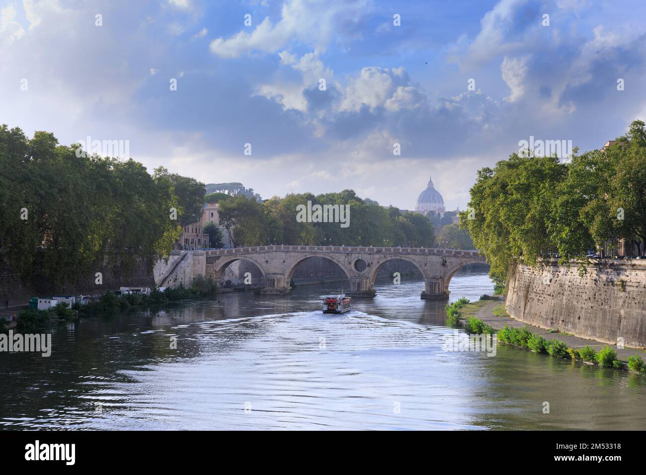 Urban view of Rome in Italy: River Tiber with Ponte Sisto and St. Peter's Basilica in the distance. Stock Photo