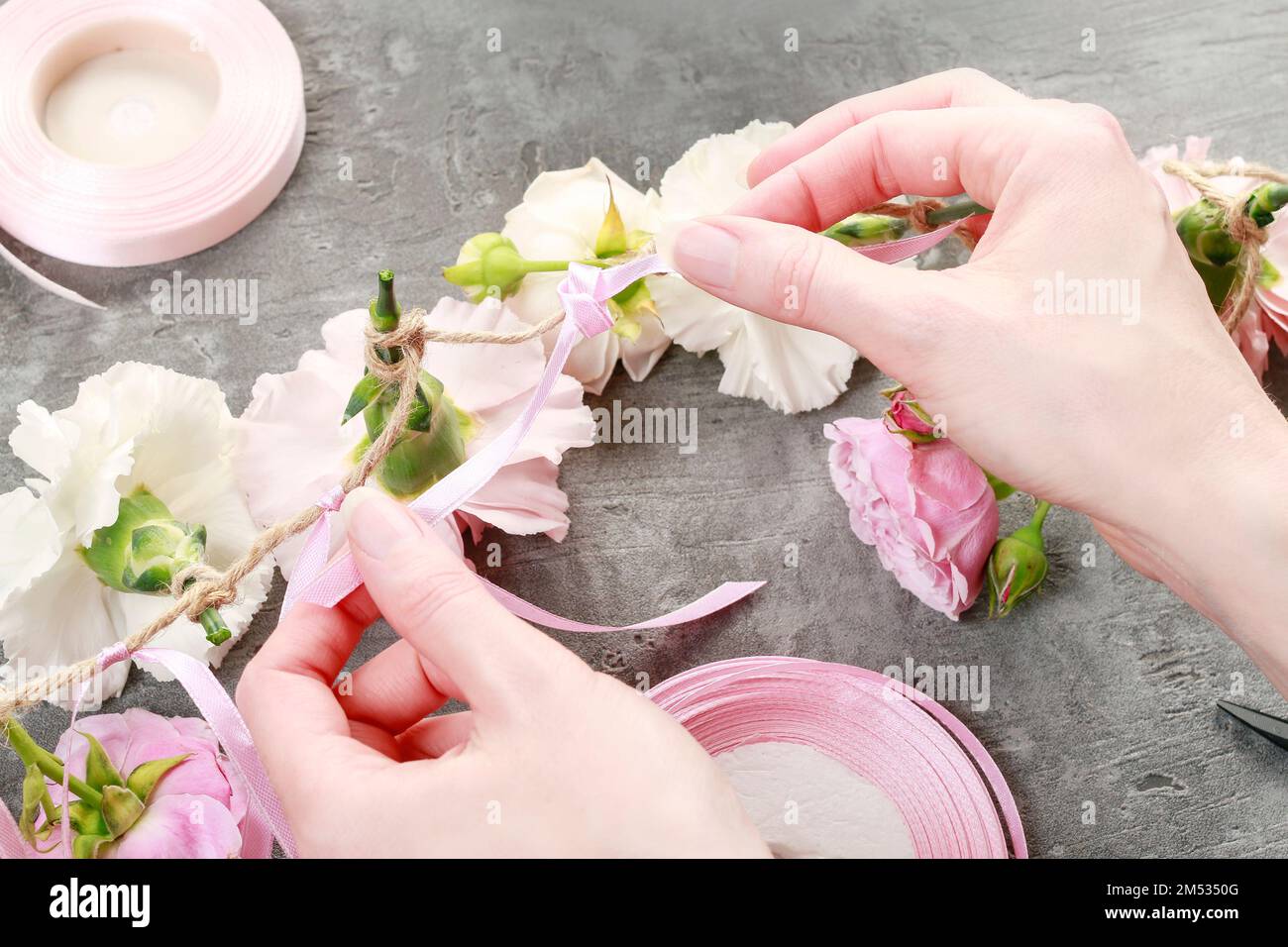 Florist at work how to make a flower garland for wedding or other
