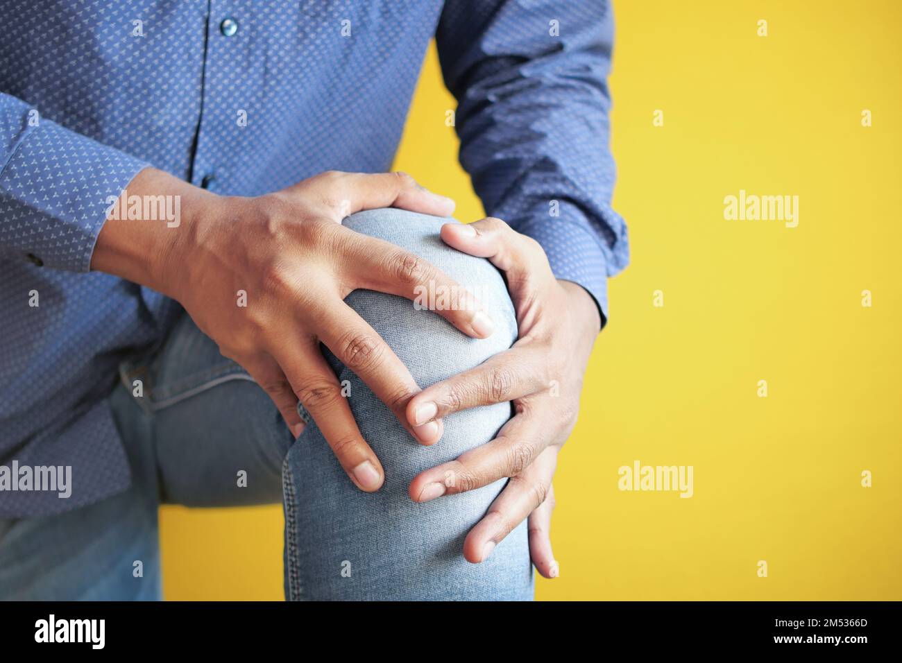 Close up on man suffering knee joint pain Stock Photo