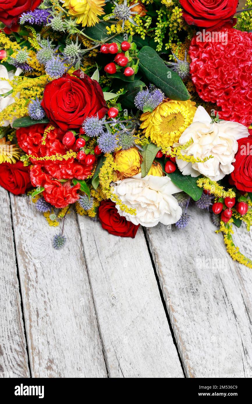 Bouquet of red roses, celosias and white carnations. Party decor Stock Photo