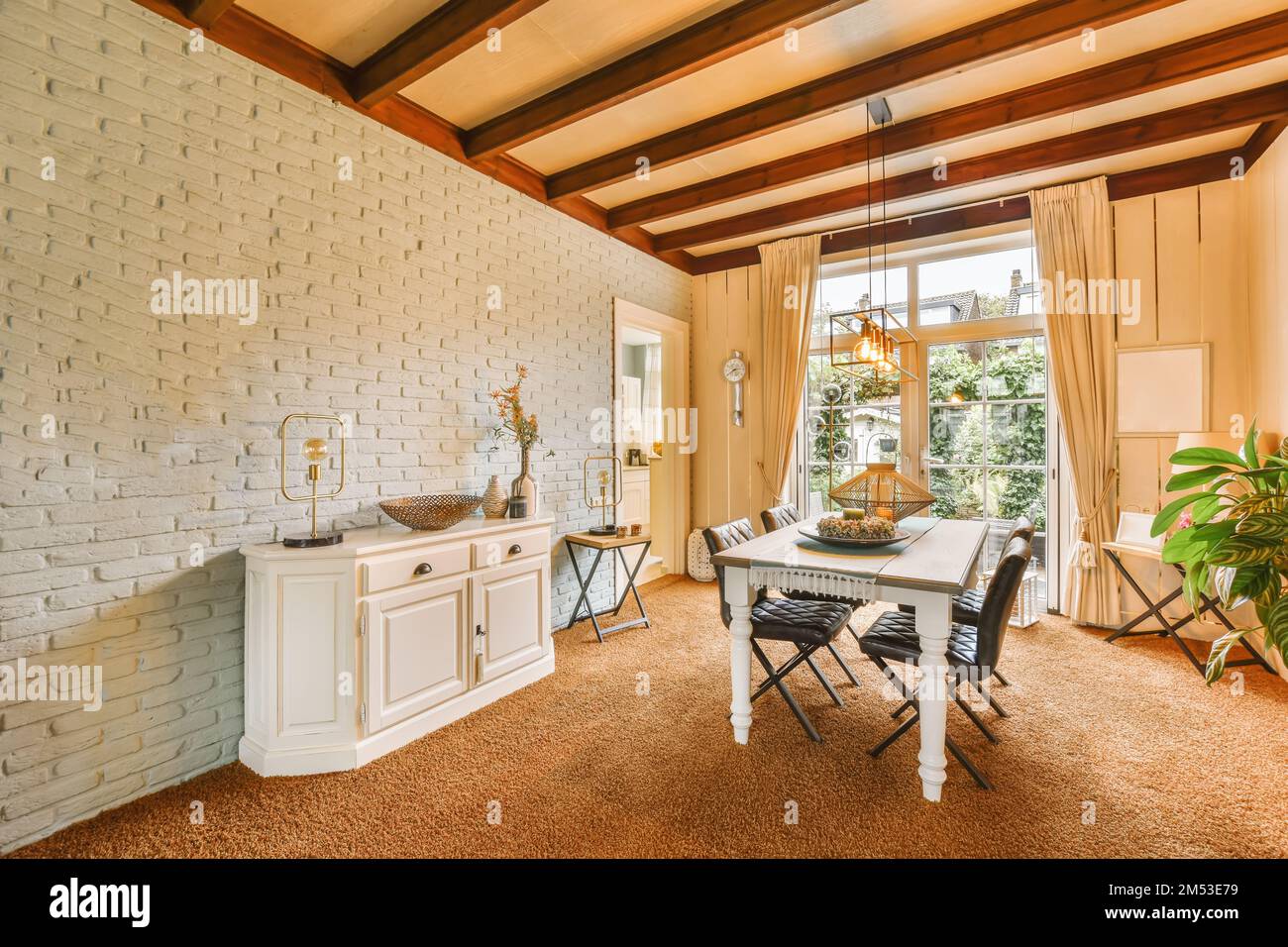 a dining room with white brick walls and wood trim around the window